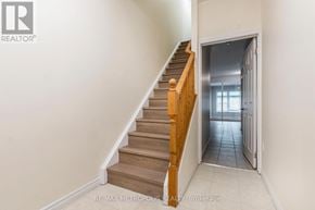 Waterloo townhouse for rent - A staircase with wooden steps and a white wall.
