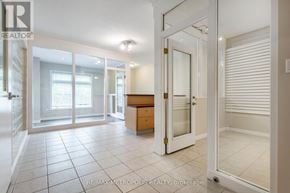 Waterloo townhouse for rent - A spacious room with a white door and a tiled floor.