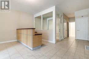 Waterloo townhouse for rent - A realtor's office with a white door and a brown reception desk.