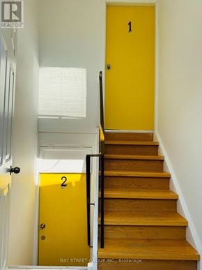 Oshawa (Lakeview) house for rent - A yellow door with the number 2 on it is next to a staircase.