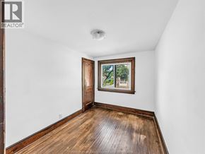 Windsor duplex for rent - A room with a wooden floor and a window with a view of trees.