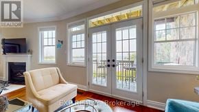 Collingwood townhouse for rent - A living room with a fireplace and a chair.