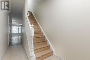 Waterloo townhouse for rent - A hallway with a staircase leading to a door.
