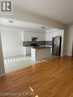 Hamilton townhouse for rent - A kitchen with a refrigerator, sink, and stove.