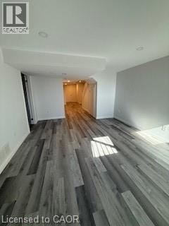 Hamilton townhouse for rent - A room with wooden flooring and a doorway leading to another room.