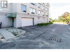 Waterloo condo for rent - A building with a closed garage door and a sign that says REMAX METROPOLITIS REALTOR.