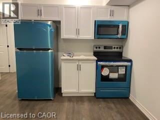 St. Catharines house for rent - A blue refrigerator and a blue microwave oven in a kitchen.