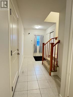 Welland (Coyle Creek) townhouse for rent - A hallway with a staircase and a window.