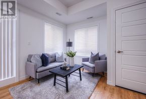 Kitchener condo for rent - A living room with a grey couch, a black coffee table, and a grey armchair.