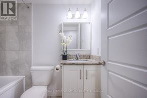 Kitchener condo for rent - A white bathroom with a toilet, sink, and bathtub.