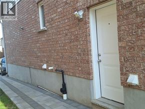 Kitchener house for rent - A red brick house with a white door and a sign that says REALTOR.