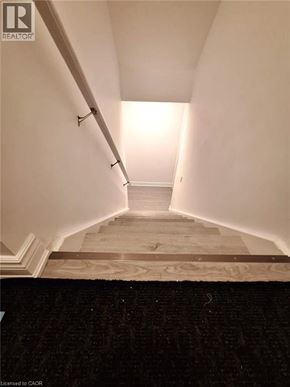 Kitchener house for rent - A long hallway with a light at the end.