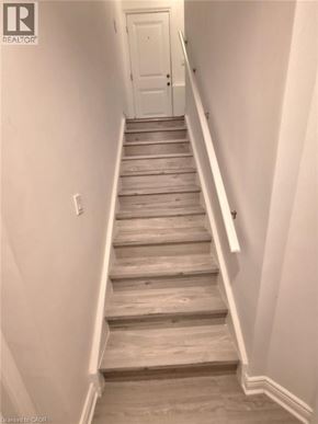Kitchener house for rent - A staircase with wooden steps and white walls.