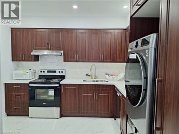 Kitchener house for rent - A modern kitchen with wooden cabinets and stainless steel appliances.