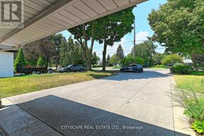 Burlington (Bayview) house for rent - A car is parked on a driveway in front of a house.