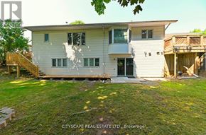Burlington (Bayview) house for rent - A two-story house with a deck and a tree in the front yard.