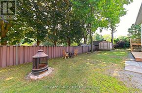 Burlington (Bayview) house for rent - A backyard with a fence, a lantern, and a wooden deck.
