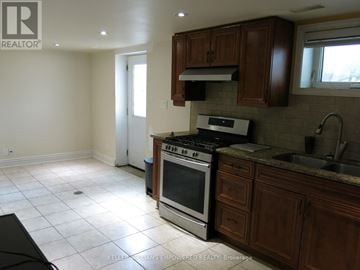 Toronto (Downsview-Roding-Cfb) house for rent - A kitchen with a stove top oven and a sink.