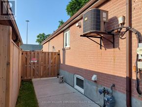 Toronto (Downsview-Roding-Cfb) house for rent - A red brick house with a wooden fence and a sign that says "No Trespassing".