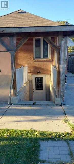 Toronto (Downsview-Roding-Cfb) house for rent - A house with a brown brick exterior and a white door.
