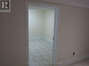 Toronto (Downsview-Roding-Cfb) house for rent - A white door in a room with a tiled floor.