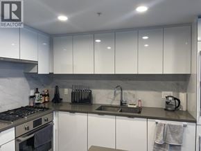 Richmond apartment for rent - A kitchen with white cabinets and a stove top oven.