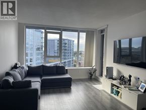 Richmond apartment for rent - A living room with a large window and a view of a cityscape.