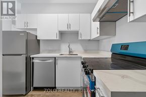 Chatham-Kent (Wallaceburg) multi-family for rent - A kitchen with white cabinets and a blue counter.
