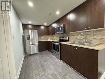 Georgina (Keswick North) house for rent - A kitchen with wooden cabinets and a stainless steel refrigerator.