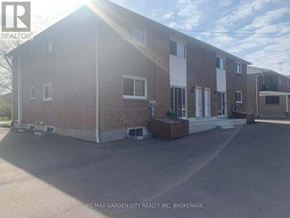 St. Catharines (Glendale/Glenridge) fourplex for rent - A building with the text RE/MAX GARDEN CITY REALTY INC. BROKERAGE on the bottom.