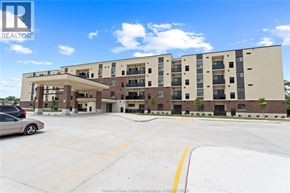 Mcgregor apartment for rent - A large apartment complex with a parking lot in front.