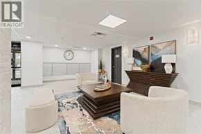 Mcgregor apartment for rent - A modern office lobby with a wooden coffee table and two white chairs.