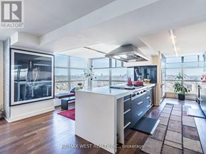 Toronto (Rosedale-Moore Park) condo for rent - A modern kitchen with a large island and a view of the city.