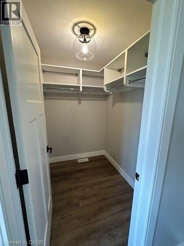 Ingersoll townhouse for rent - A small bedroom with a bunk bed and a light on.