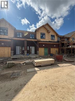 Ingersoll townhouse for rent - A house under construction with a clear sky.