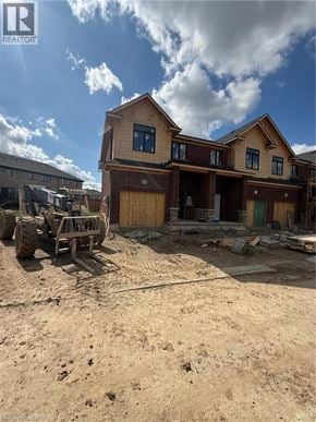 Ingersoll townhouse for rent - A construction site with a partially built house and construction machinery.