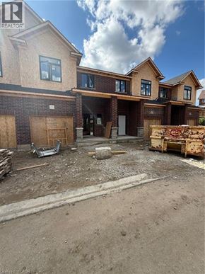 Ingersoll townhouse for rent - A house under construction with a partially completed brick wall.