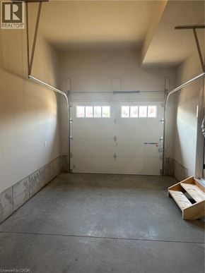 Ingersoll townhouse for rent - A garage with a white door and windows.
