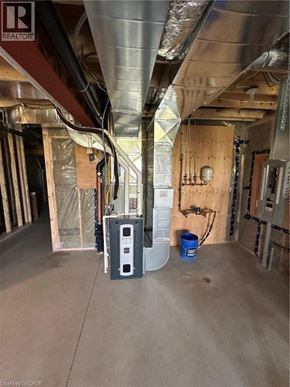 Ingersoll townhouse for rent - A room under construction with a blue barrel and a white box on the floor.