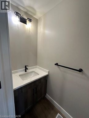 Ingersoll townhouse for rent - A small bathroom with a sink and a towel bar.