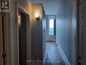 For rent in Prescott - A hallway with a door on the left and a window on the right.