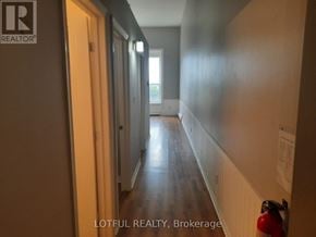 For rent in Prescott - A hallway with a fire extinguisher on the right side.