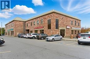 Binbrook apartment for rent - A building with a parking lot in front of it.
