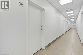 Binbrook apartment for rent - A long hallway with doors on both sides and a sign that says 204.