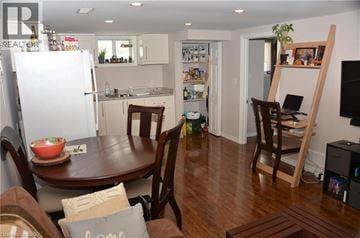 Hamilton house for rent - A kitchen with a table and chairs in the middle of the room.
