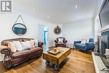 Mississauga (Hurontario) house for rent - A living room with a brown leather couch and a wooden coffee table.