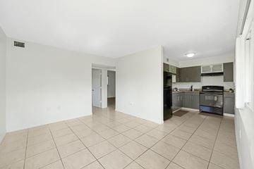 Fort Lauderdale apartment for rent - A kitchen with a black oven and white walls.
