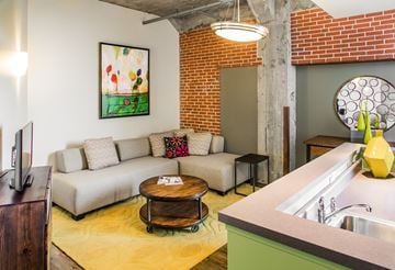 St. Louis apartment for rent - A living room with a couch, a coffee table, and a painting on the wall.