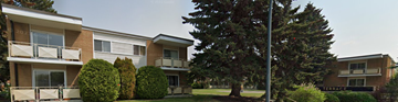 Calgary apartment for rent - Apartment building with a tree in front.