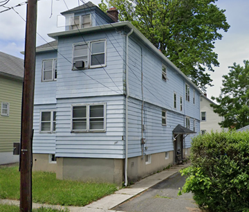Linden apartment for rent - A blue house with a white door and windows.